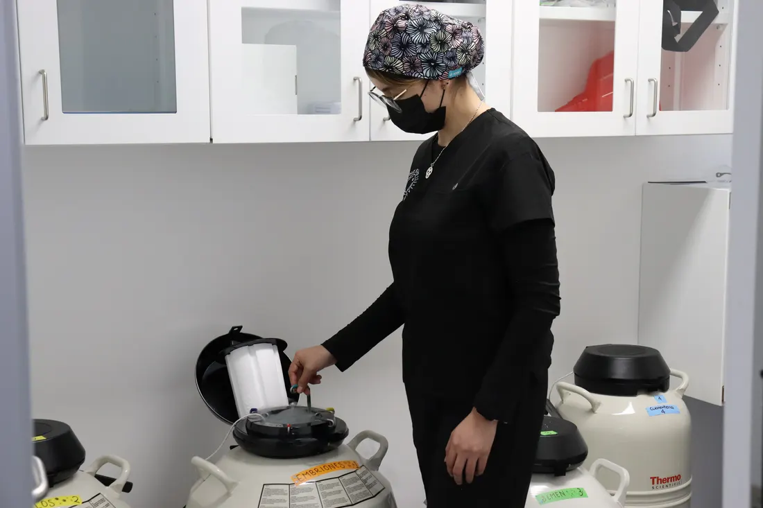 An embryologist at the cryopreservation tanks in our lab